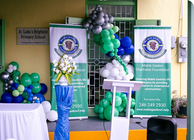 A decorated podium with balloons and banners for a school event.