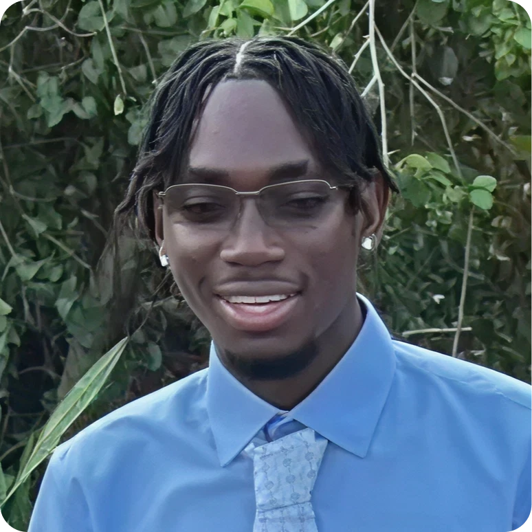 Smiling person wearing tie and earrings
